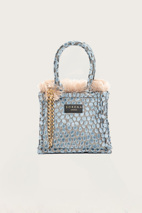 Trendy textured tote purse featuring pastel blue tufted embroidery and glamorous gold hardware accents.