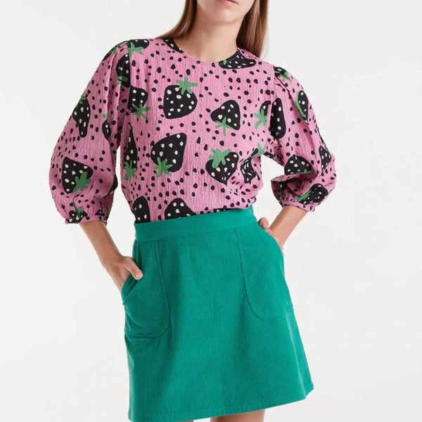 Women's pink strawberry print blouse with black fruit motifs, green accents and three-quarter balloon sleeves for playful statement style.