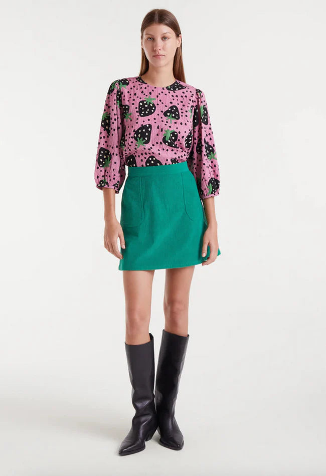 Women's playful pink blouse with bold strawberry pattern, round neckline and voluminous three-quarter sleeves for unique spring and summer fashion.