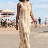 Women's sleeveless cream textured knit maxi dress with beige wave stripes, round neckline and elegant column silhouette for resort vacations.