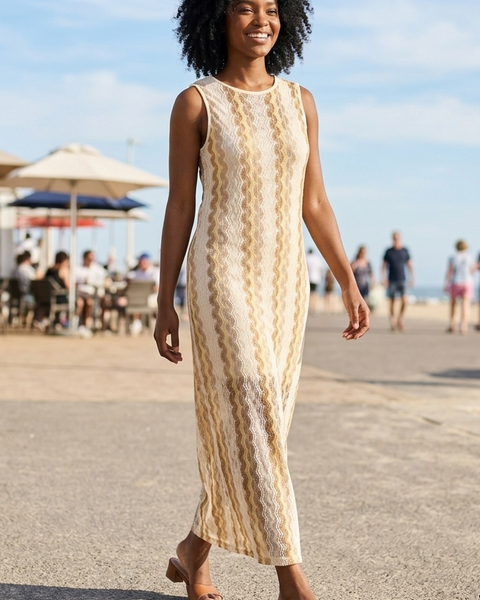 Women's sleeveless cream textured knit maxi dress with beige wave stripes, round neckline and elegant column silhouette for resort vacations.