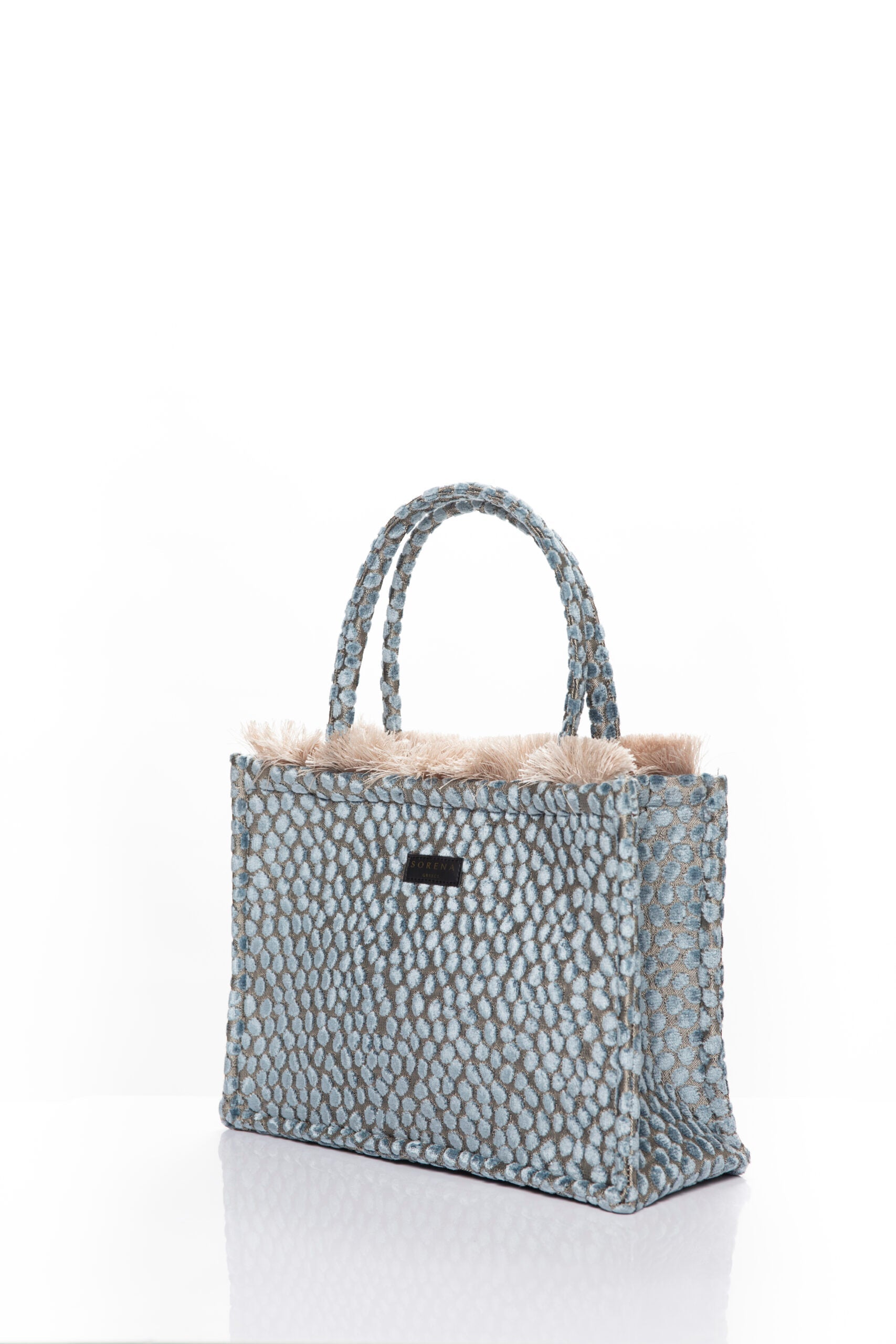 Sophisticated pastel blue handbag with textured woven finish and elevated designer-style craftsmanship.