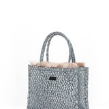 Sophisticated pastel blue handbag with textured woven finish and elevated designer-style craftsmanship.