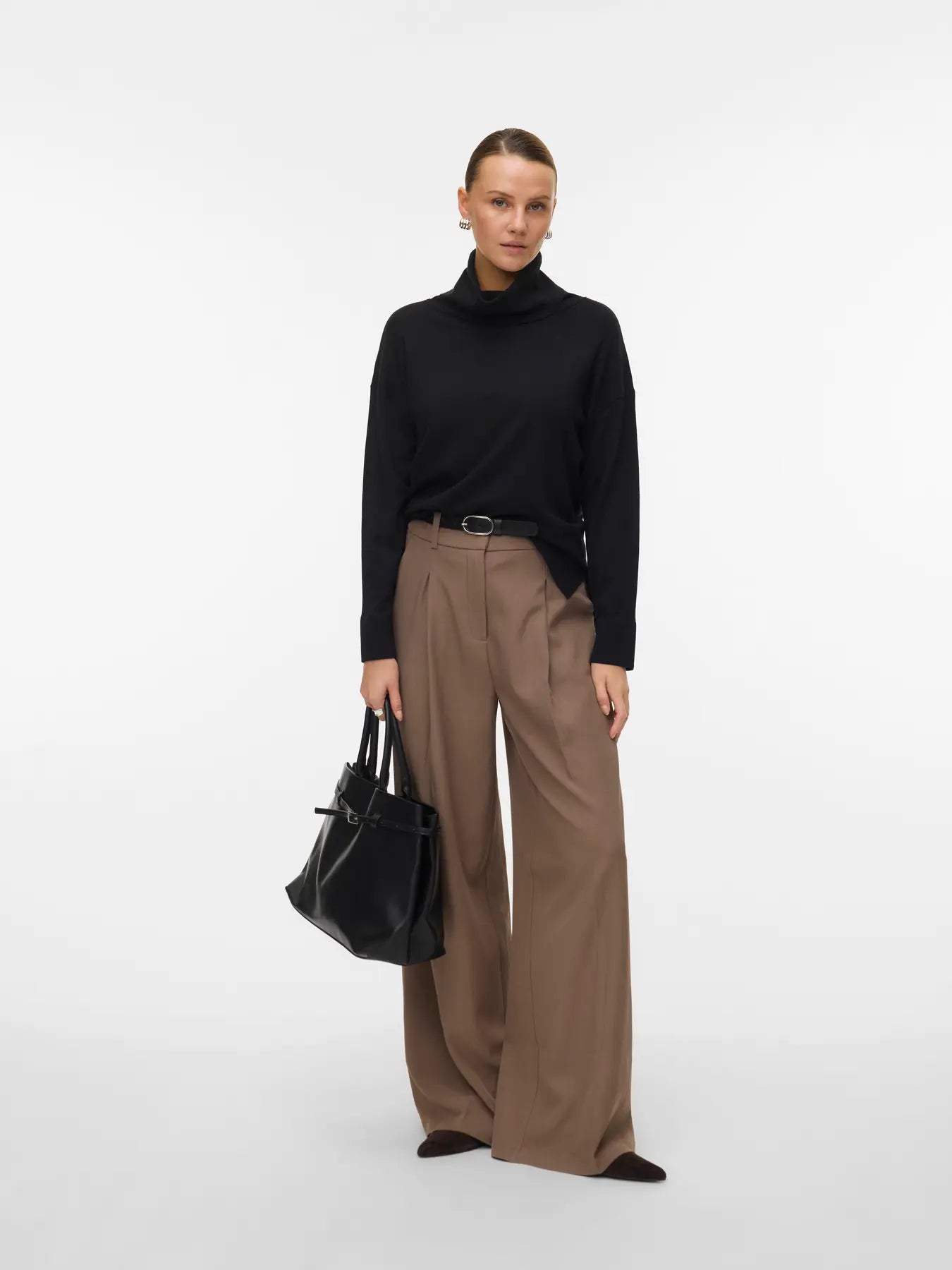 Women's timeless black roll-neck sweater with long sleeves and relaxed fit for an elevated capsule wardrobe.