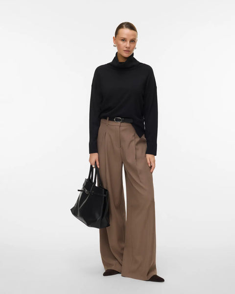 Women's timeless black roll-neck sweater with long sleeves and relaxed fit for an elevated capsule wardrobe.