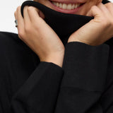 Women's timeless black roll-neck sweater with long sleeves and relaxed fit for an elevated capsule wardrobe.