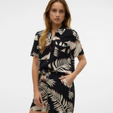 Boutique-style short sleeve top with abstract palm print and contemporary vacation-ready energy.