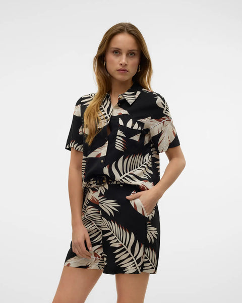 Boutique-style short sleeve top with abstract palm print and contemporary vacation-ready energy.