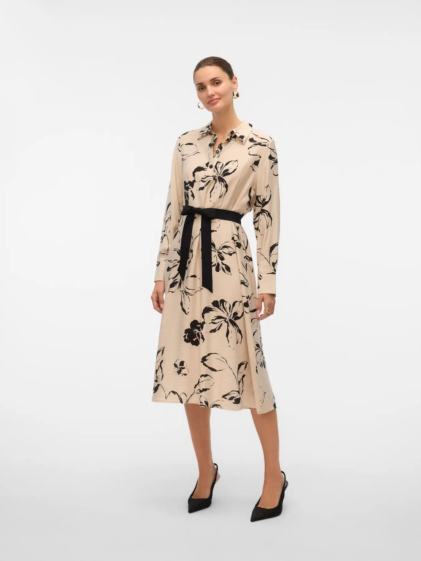 Women's long-sleeve floral shirt dress in neutral beige and black with a defined waist and flowing midi-length skirt.