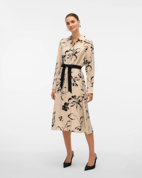 Women's long-sleeve floral shirt dress in neutral beige and black with a defined waist and flowing midi-length skirt.