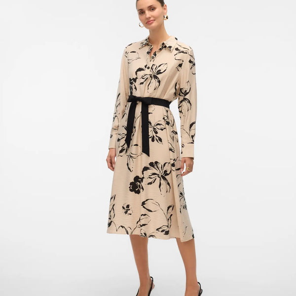 Women's long-sleeve floral shirt dress in neutral beige and black with a defined waist and flowing midi-length skirt.