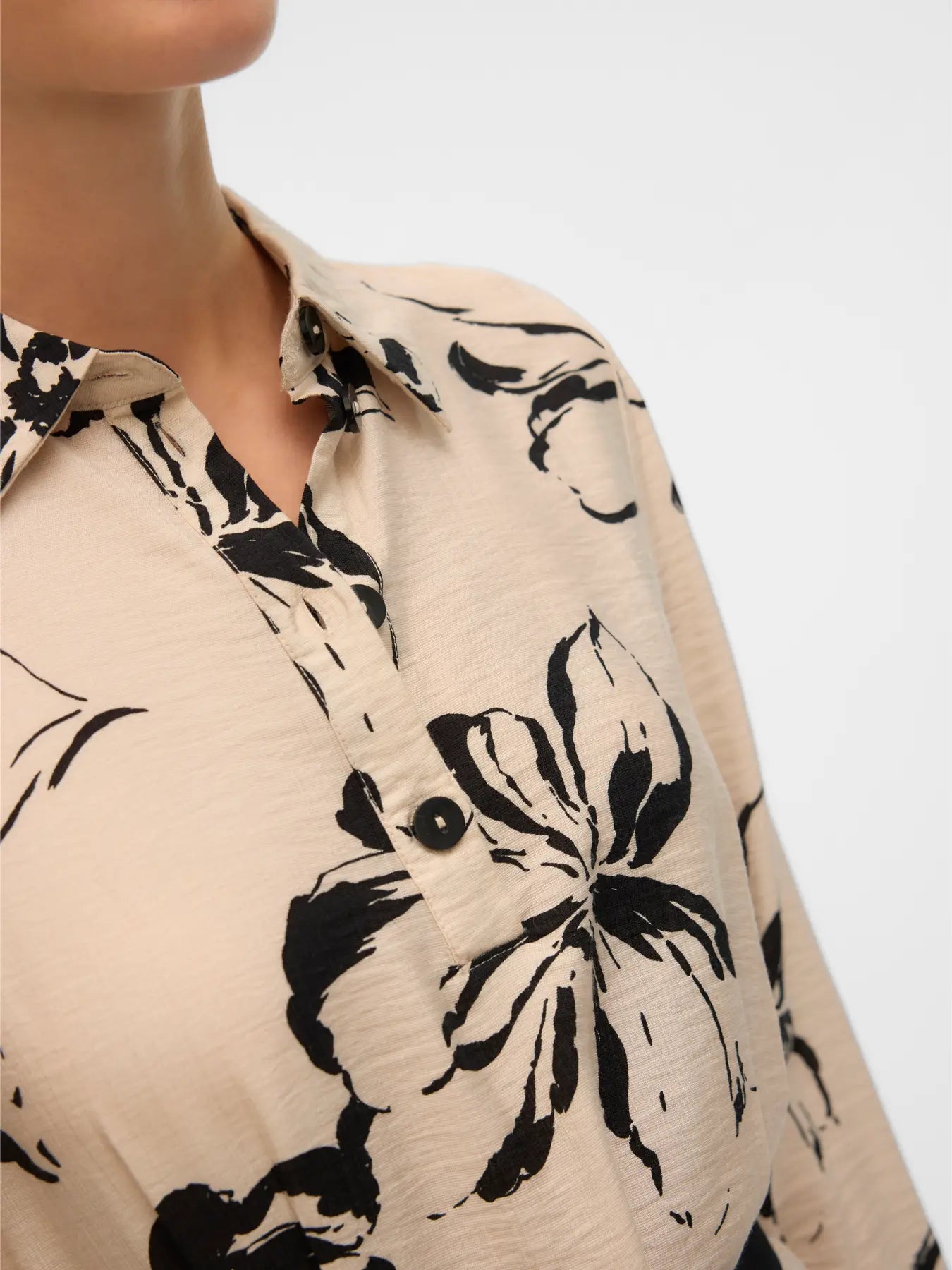 Women's cream floral midi dress featuring bold black botanical print, collared neckline and belted waist.