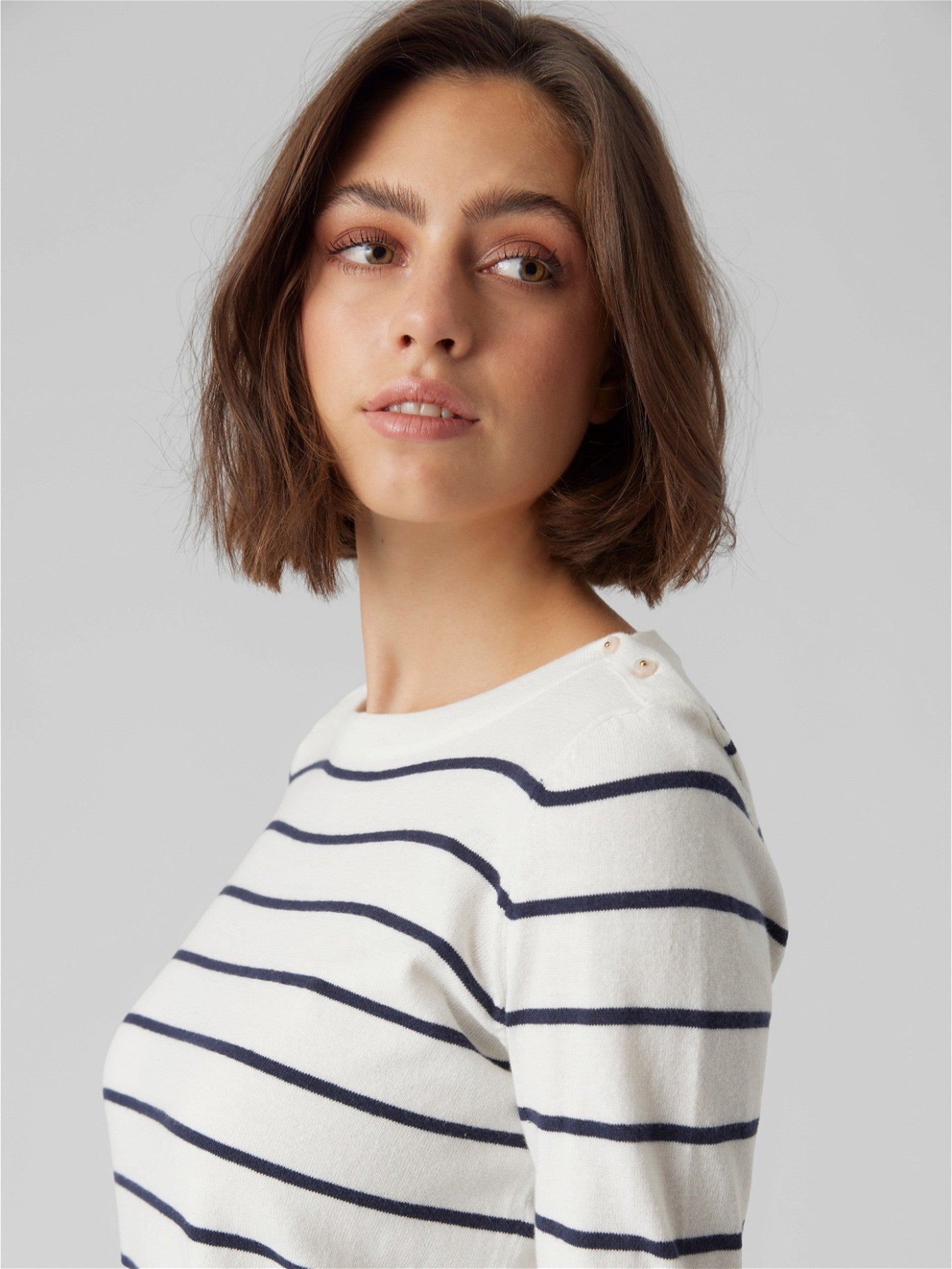 Long sleeve striped sweater with modern tailoring and Parisian-inspired fashion details.