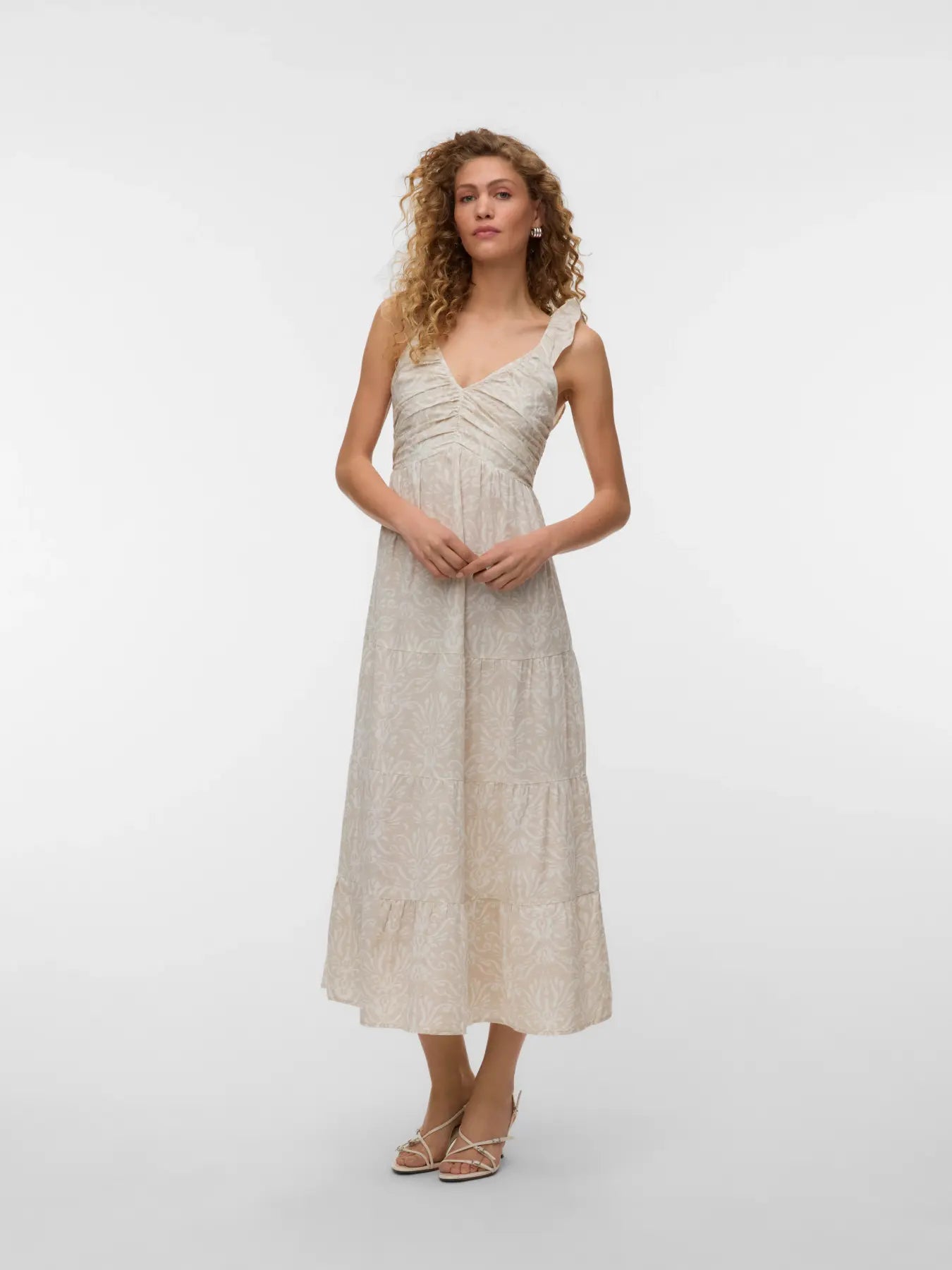 Women's ivory sleeveless midi dress featuring a textured botanical print, ruched bodice, ruffle shoulder straps, and flowing tiered skirt for timeless summer elegance.