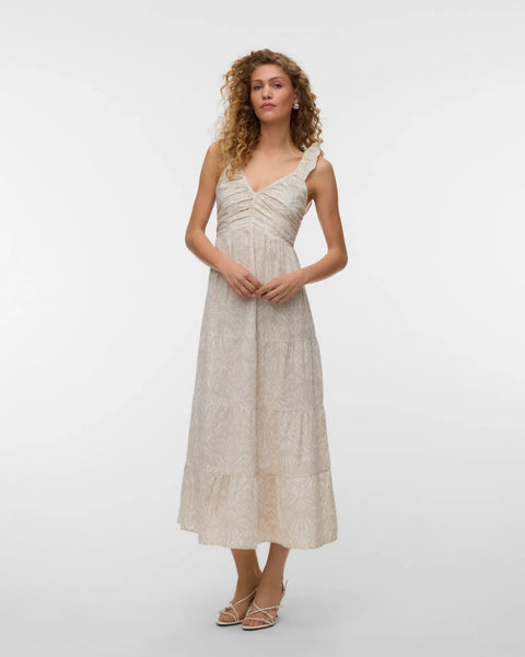 Women's ivory sleeveless midi dress featuring a textured botanical print, ruched bodice, ruffle shoulder straps, and flowing tiered skirt for timeless summer elegance.