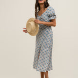 Chic floral midi dress with puff sleeves and lightweight fabric for warm-weather styling.