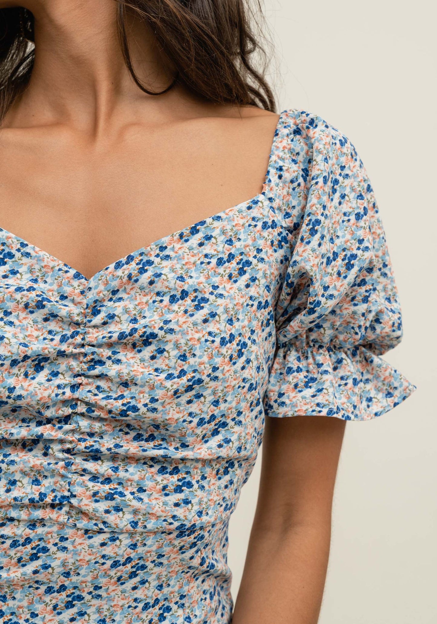 Women's blue floral midi dress with puff sleeves, sweetheart neckline, and elegant front slit.