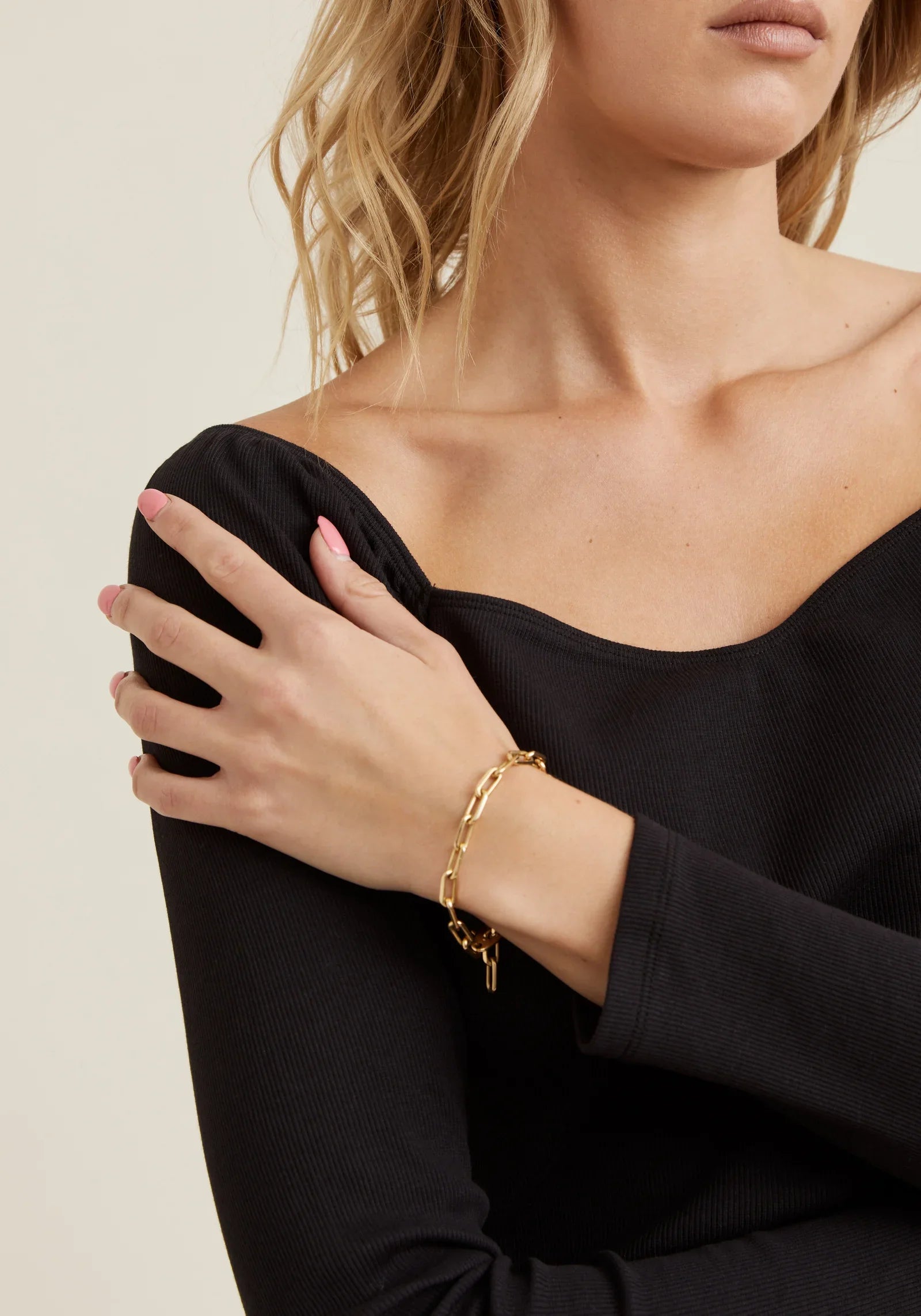 Women's fitted black top with stretch fabric and sophisticated square neckline detail.