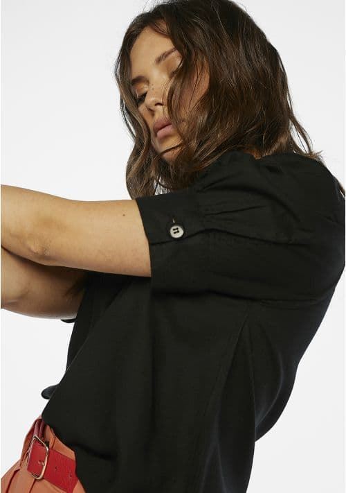 Women's black V-neck blouse with relaxed silhouette and comfortable elbow-length sleeves.