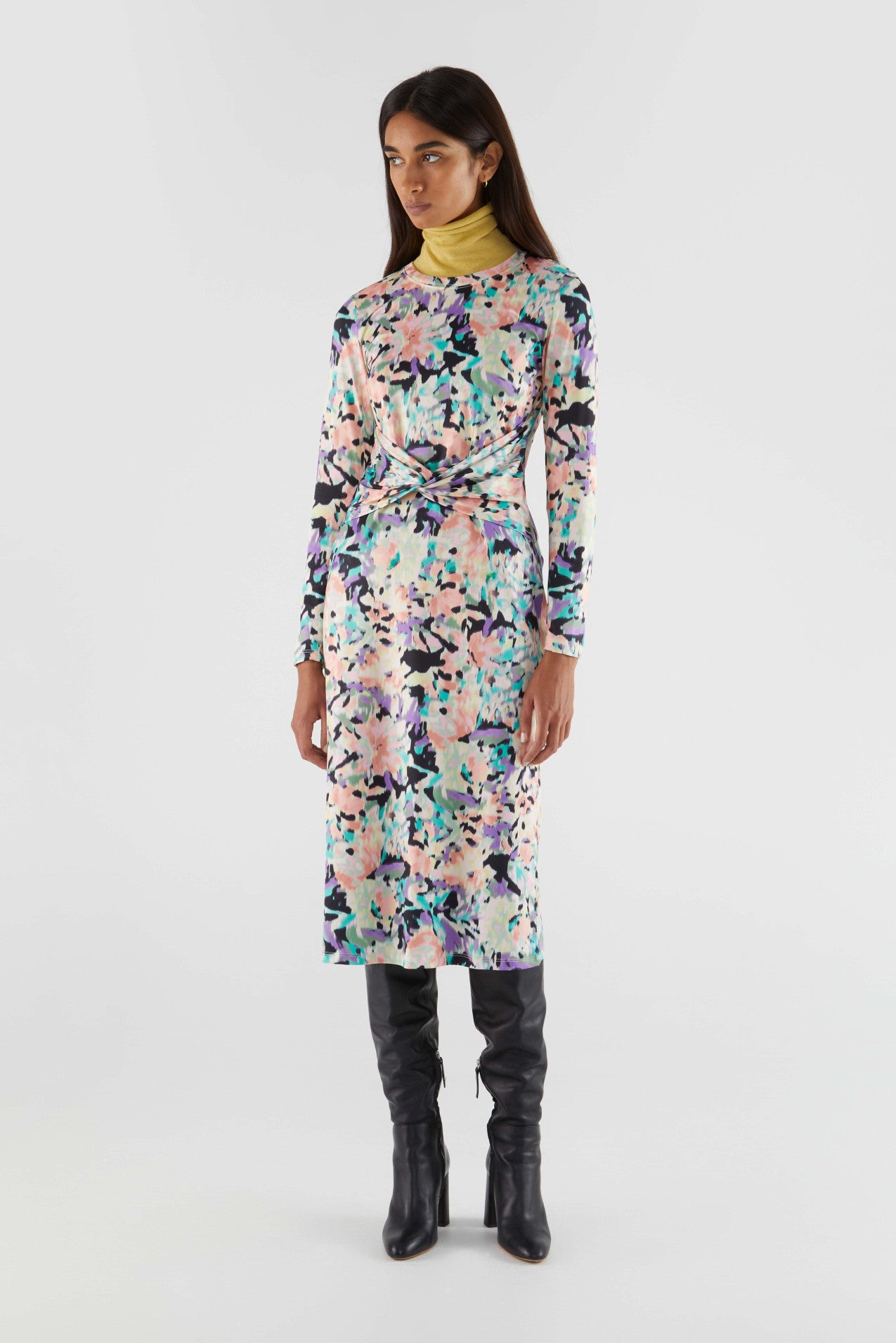 Elegant abstract print midi dress in pastel pink, lavender, teal, and black with figure-flattering ruched waist design.