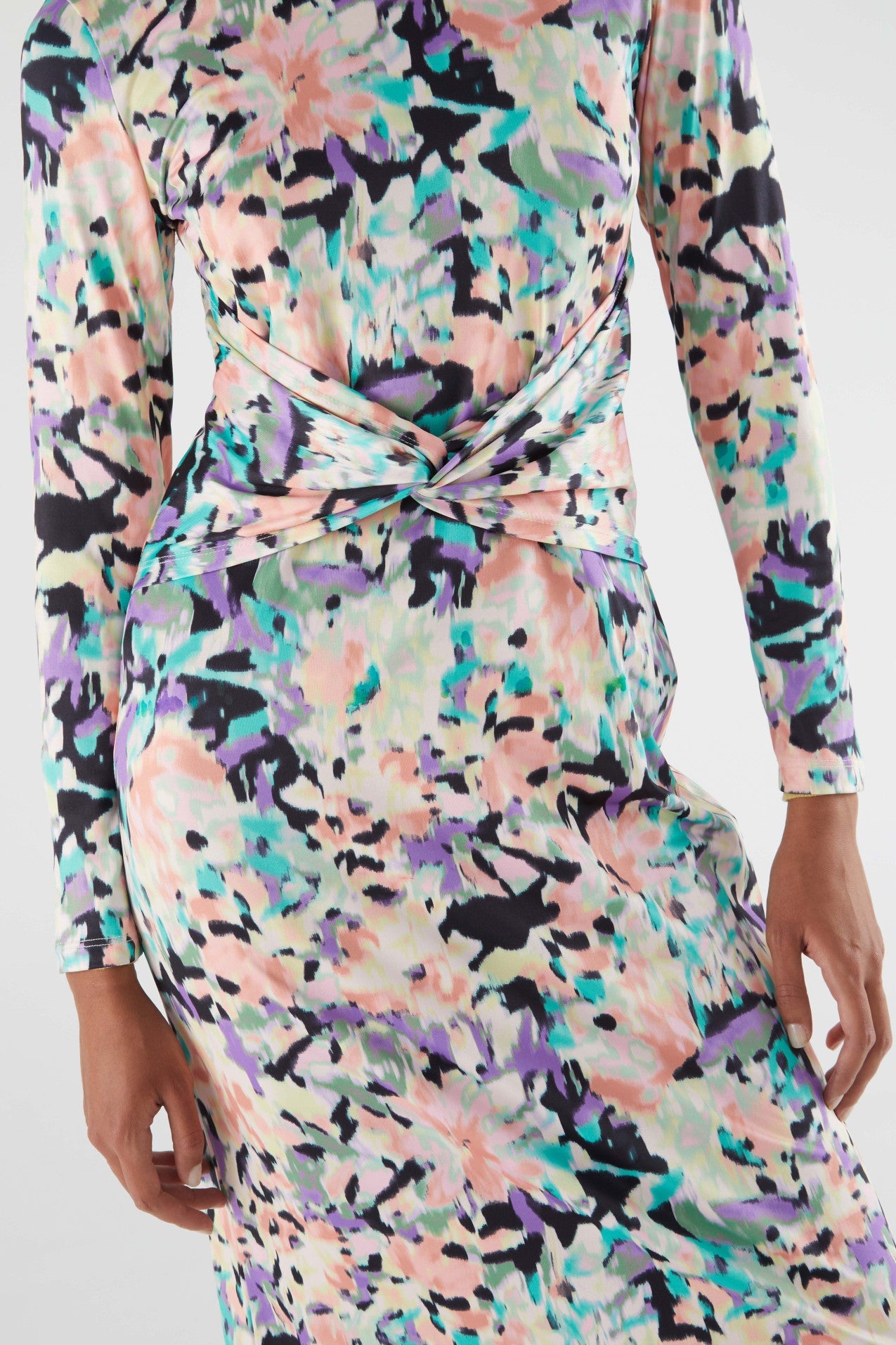 Detail of stylish women’s floral midi dress with pastel abstract print and flattering waist ruching for sophisticated casual looks.