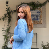 Soft blue crew neck sweater designed for layering and casual chic outfits.