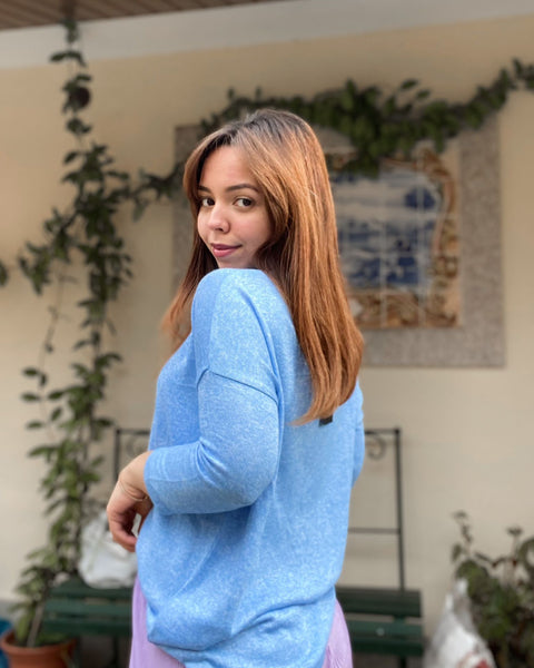 Soft blue crew neck sweater designed for layering and casual chic outfits.