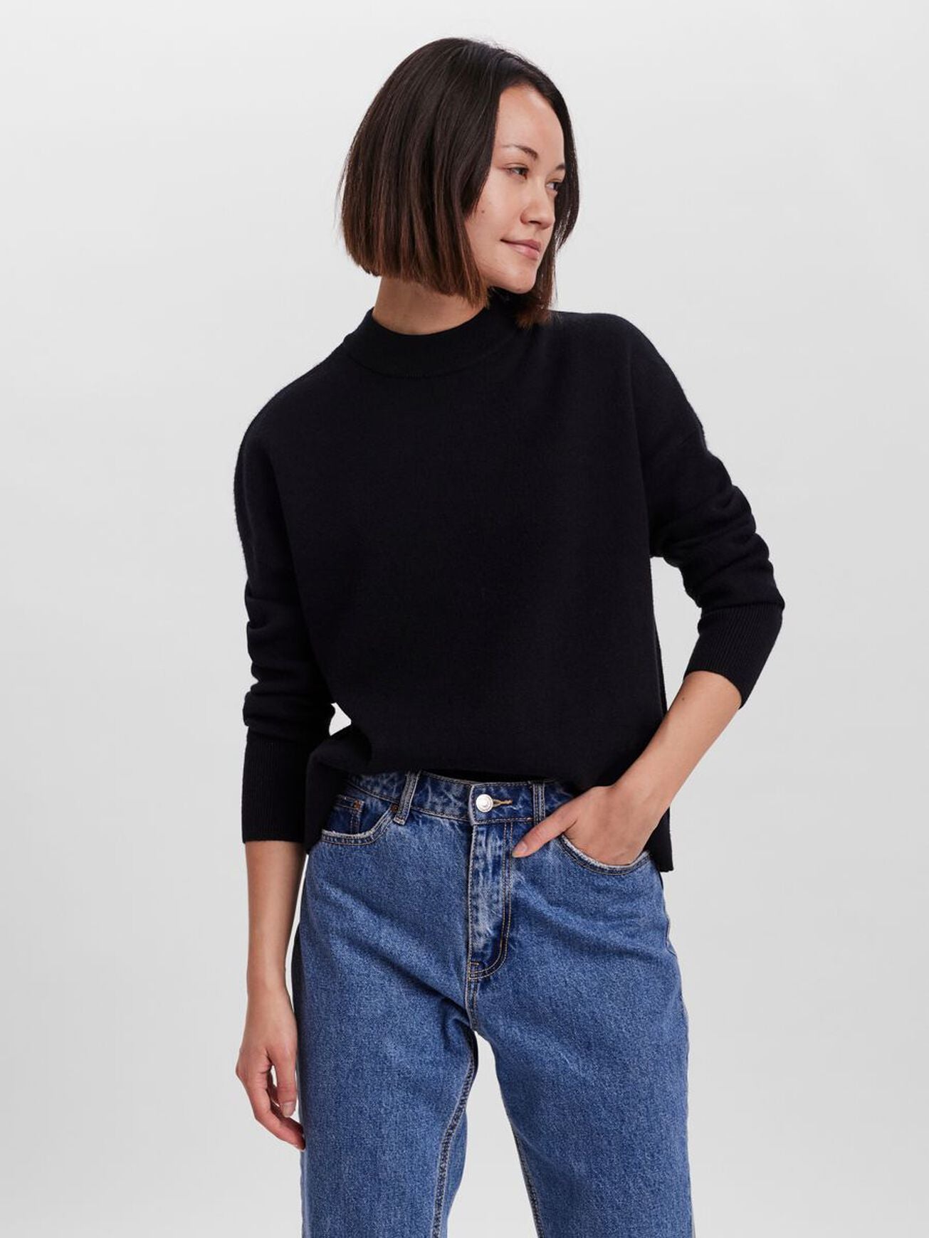 Cozy black sweater featuring a relaxed silhouette and wardrobe staple versatility.