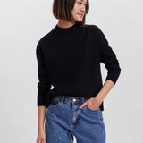 Cozy black sweater featuring a relaxed silhouette and wardrobe staple versatility.