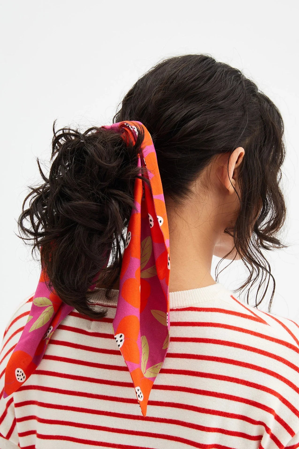 Women's fruit print scarf scrunchie in vibrant pink and orange with long ribbon tails.