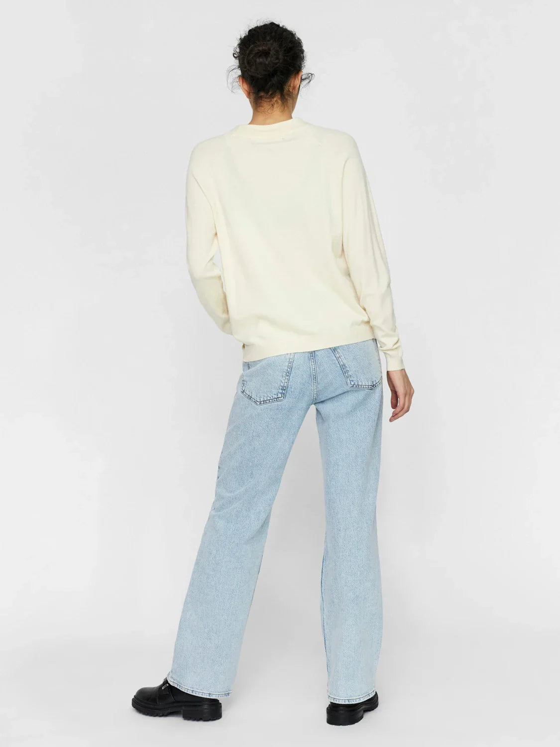 Women's off-white sweater with relaxed fit and versatile wardrobe essential appeal.