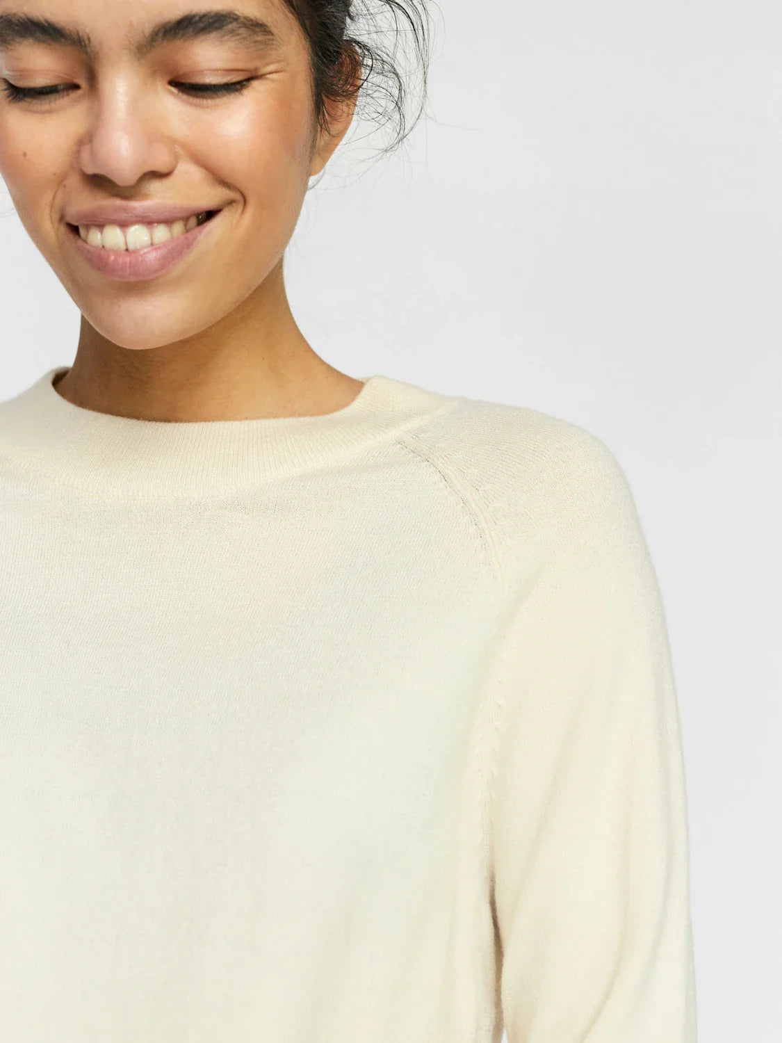 Lightweight ivory sweater with classic crew neck and effortless transitional season style.