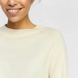 Lightweight ivory sweater with classic crew neck and effortless transitional season style.