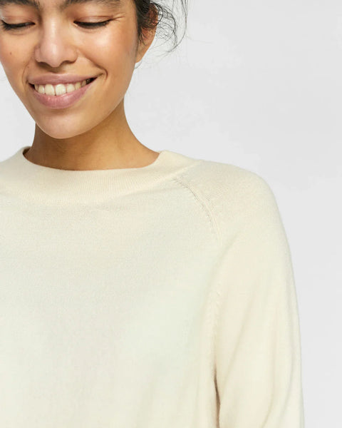Lightweight ivory sweater with classic crew neck and effortless transitional season style.
