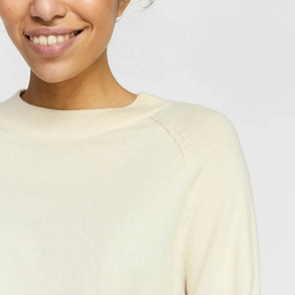 Lightweight ivory sweater with classic crew neck and effortless transitional season style.