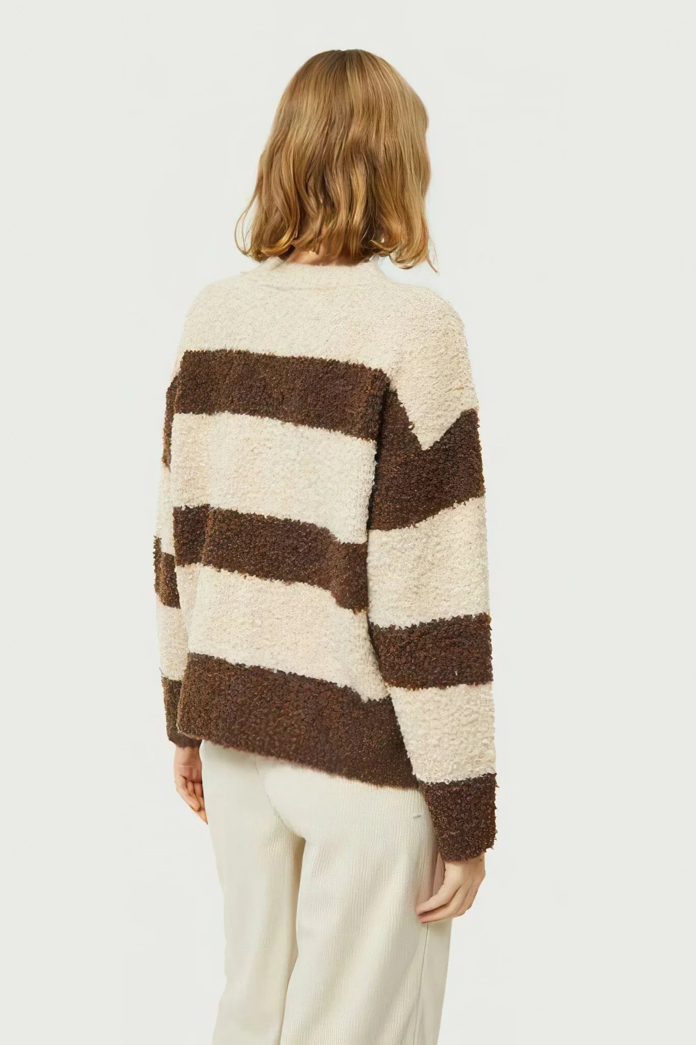 Soft boucle stripe sweater for women with oversized fit and cozy Scandinavian-inspired winter fashion.