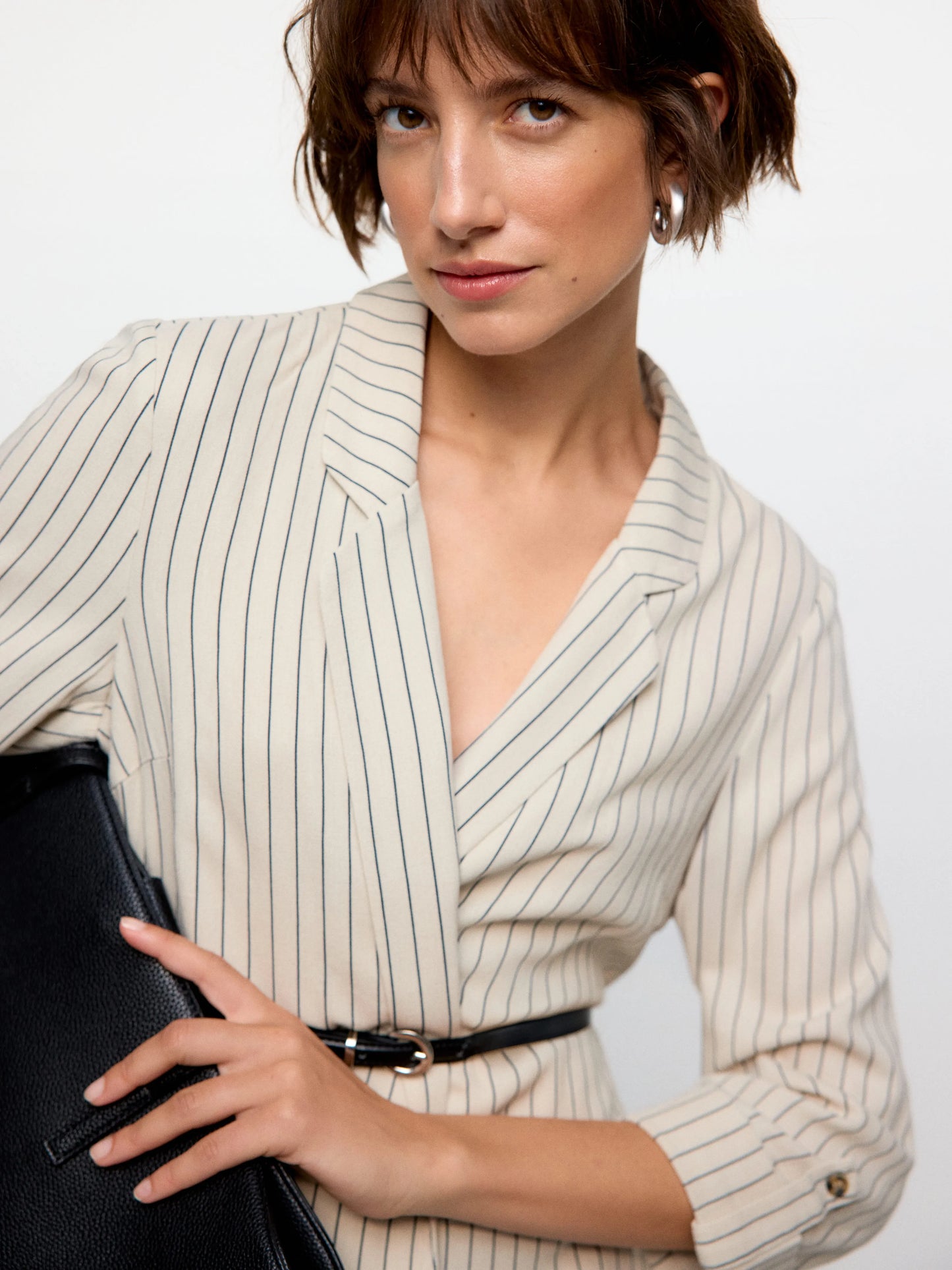 Stylish off-white pinstripe blazer with structured fit and effortless contemporary street-style fashion aesthetic.
