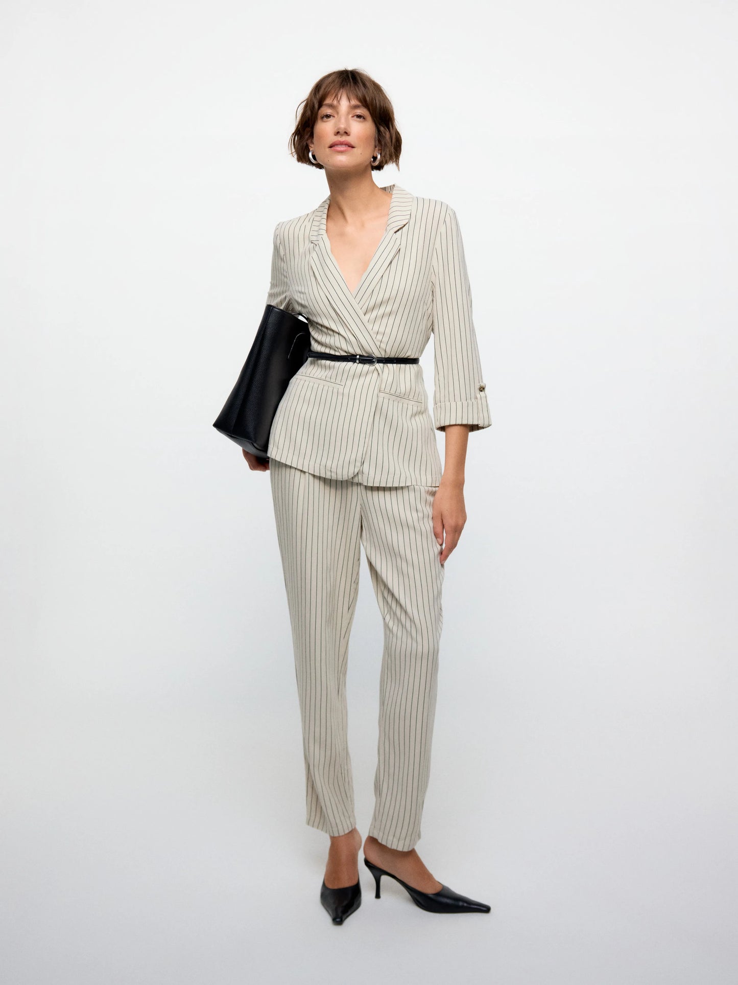 Modern women’s tailored blazer layered over casual denim for polished everyday smart-casual fashion looks.
