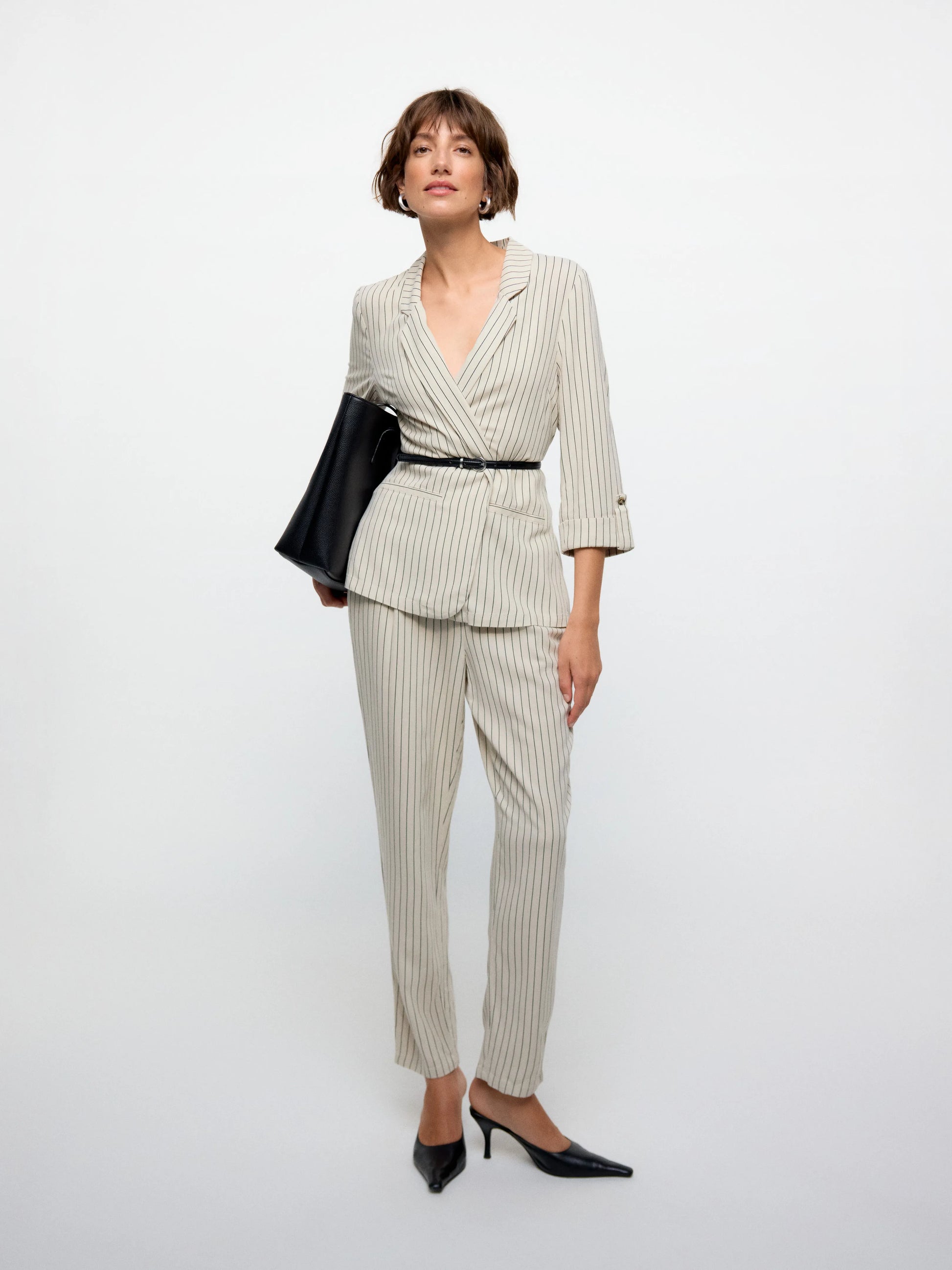 Modern women’s tailored blazer layered over casual denim for polished everyday smart-casual fashion looks.