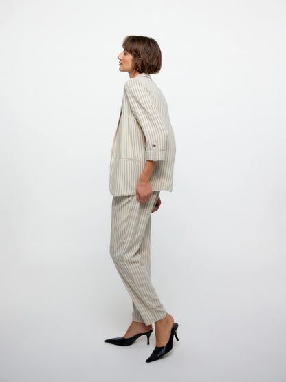 Trendy gray pinstripe off-white blazer with tailored silhouette and contemporary workwear-inspired street-style appeal.