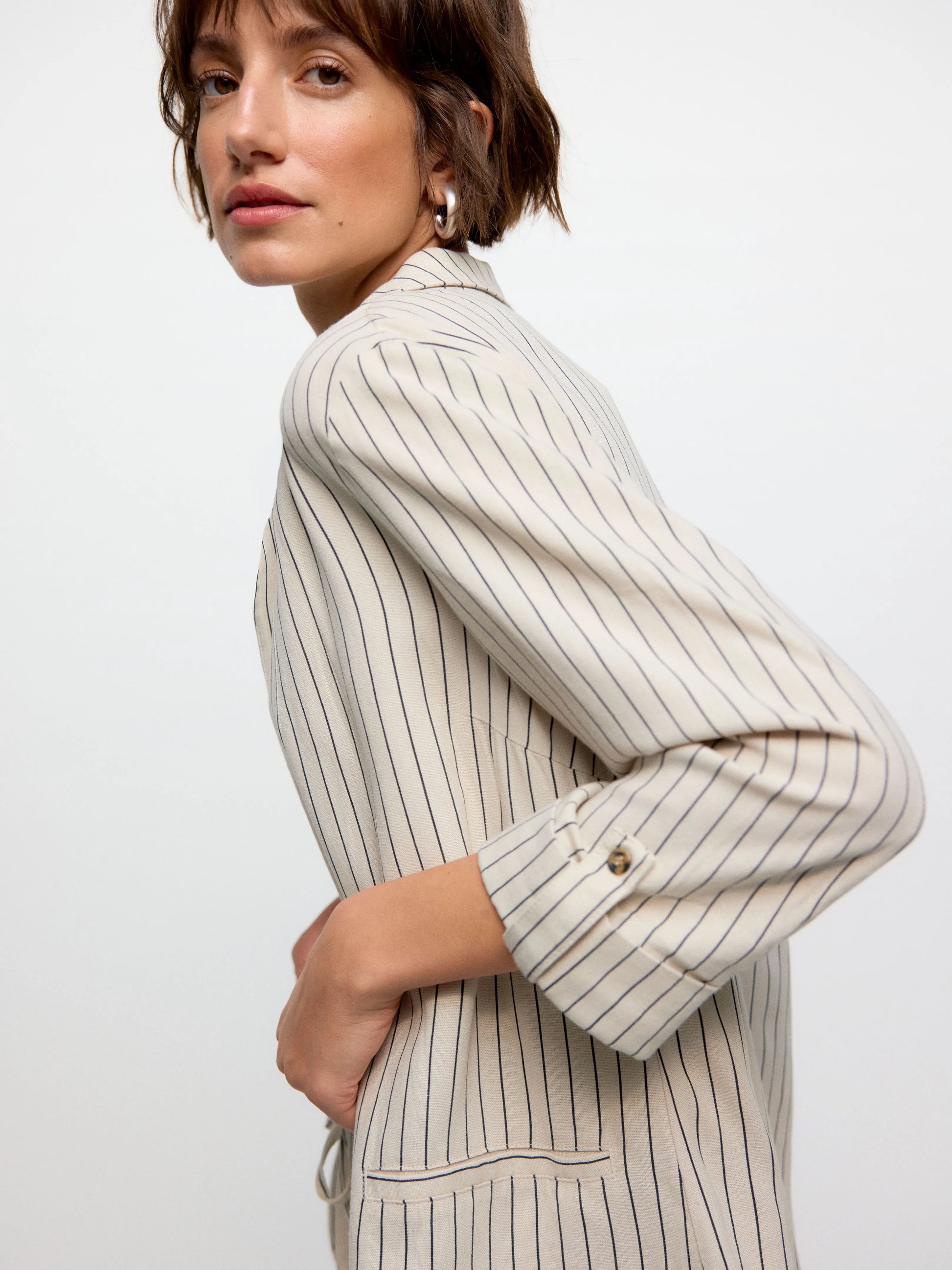 Contemporary women’s pinstripe blazer featuring tailored lines and modern business-casual fashion appeal.