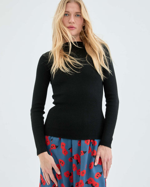 Soft black ribbed knit sweater with long sleeves and flattering slim silhouette for trendy capsule wardrobe styling.