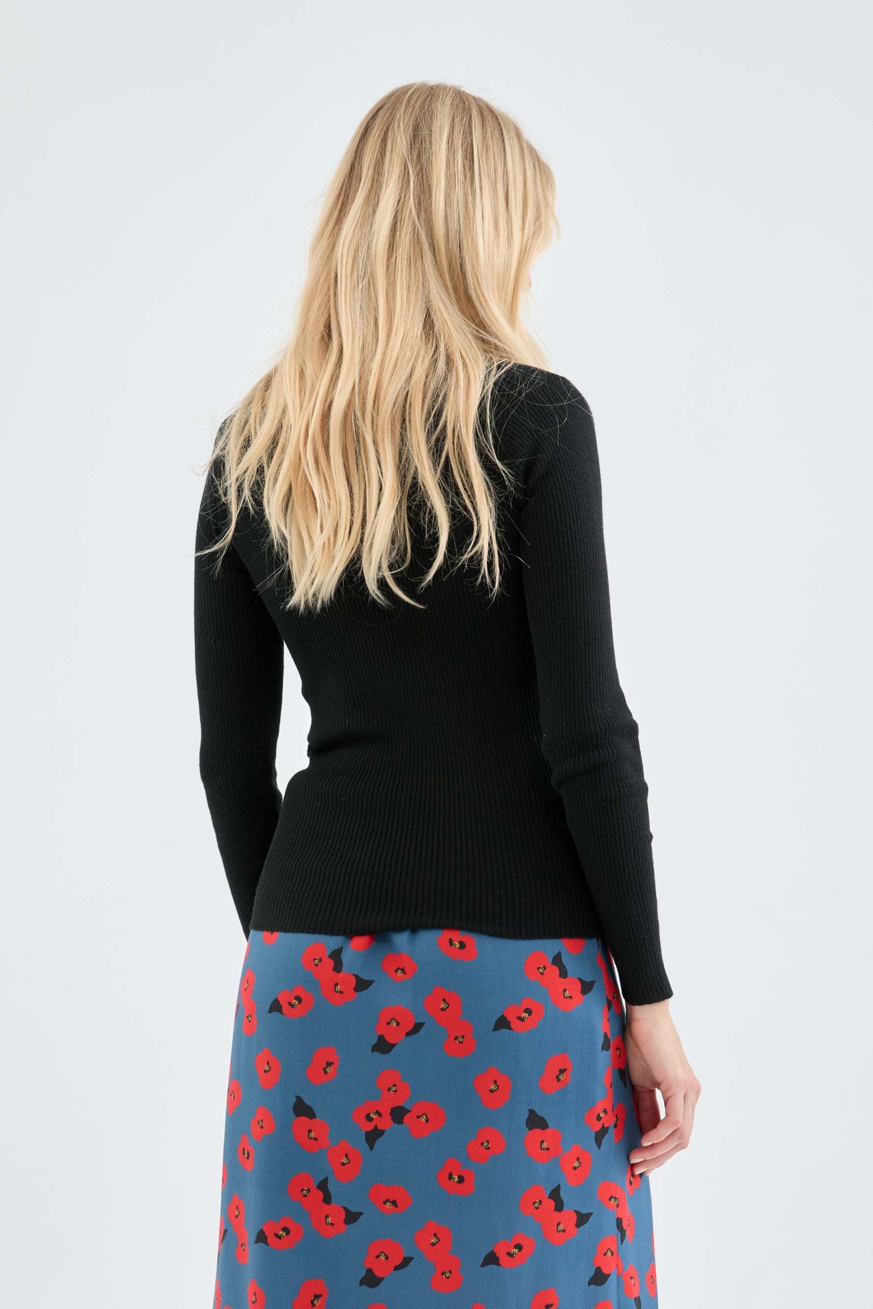 Elegant black long sleeve ribbed sweater for women with flattering tailored fit and timeless fashion versatility.