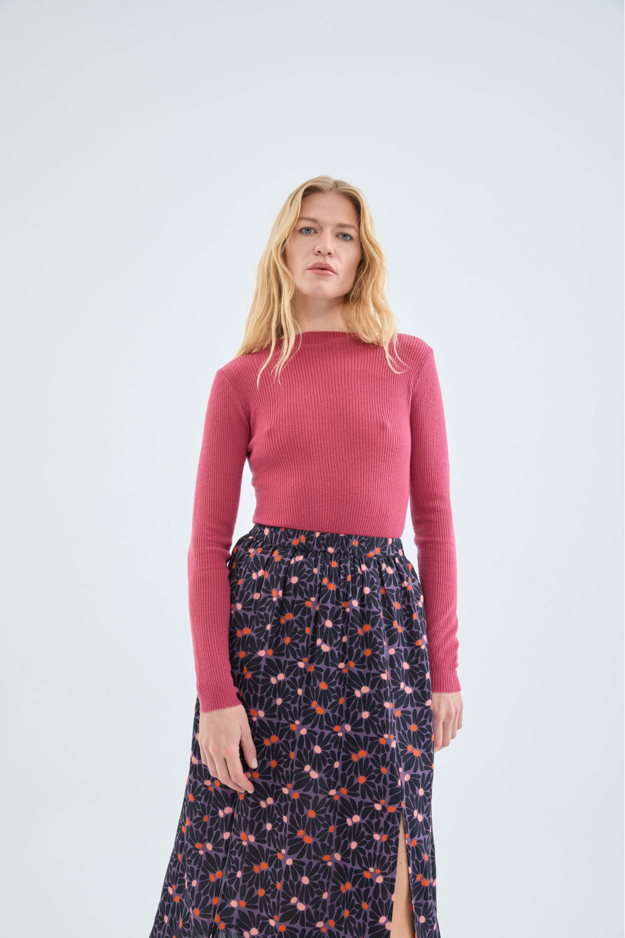 Women’s essential pink sweater with textured rib knit design and elegant fitted shape for polished casual looks.