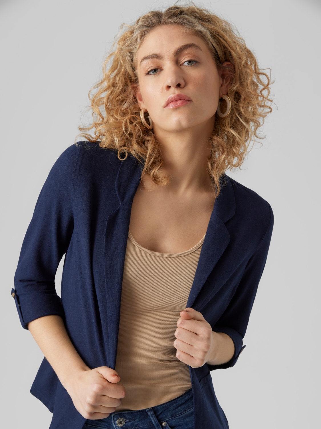 Navy open-front blazer with rolled sleeves and tailored silhouette for women.