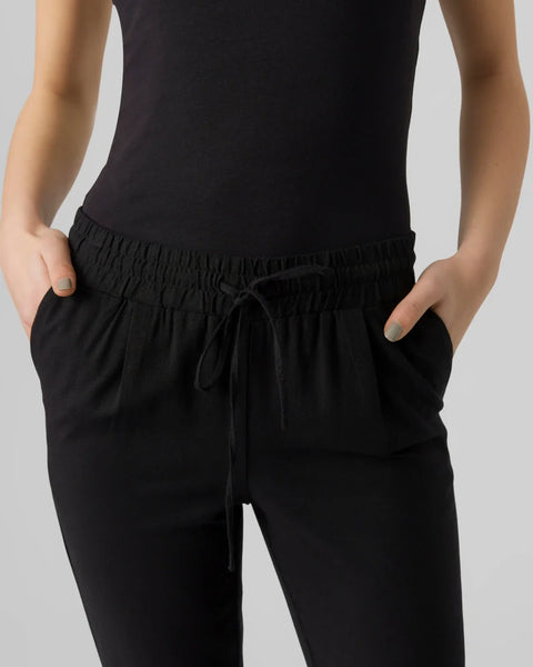 Women's black drawstring pants with tapered leg and elastic waistband.