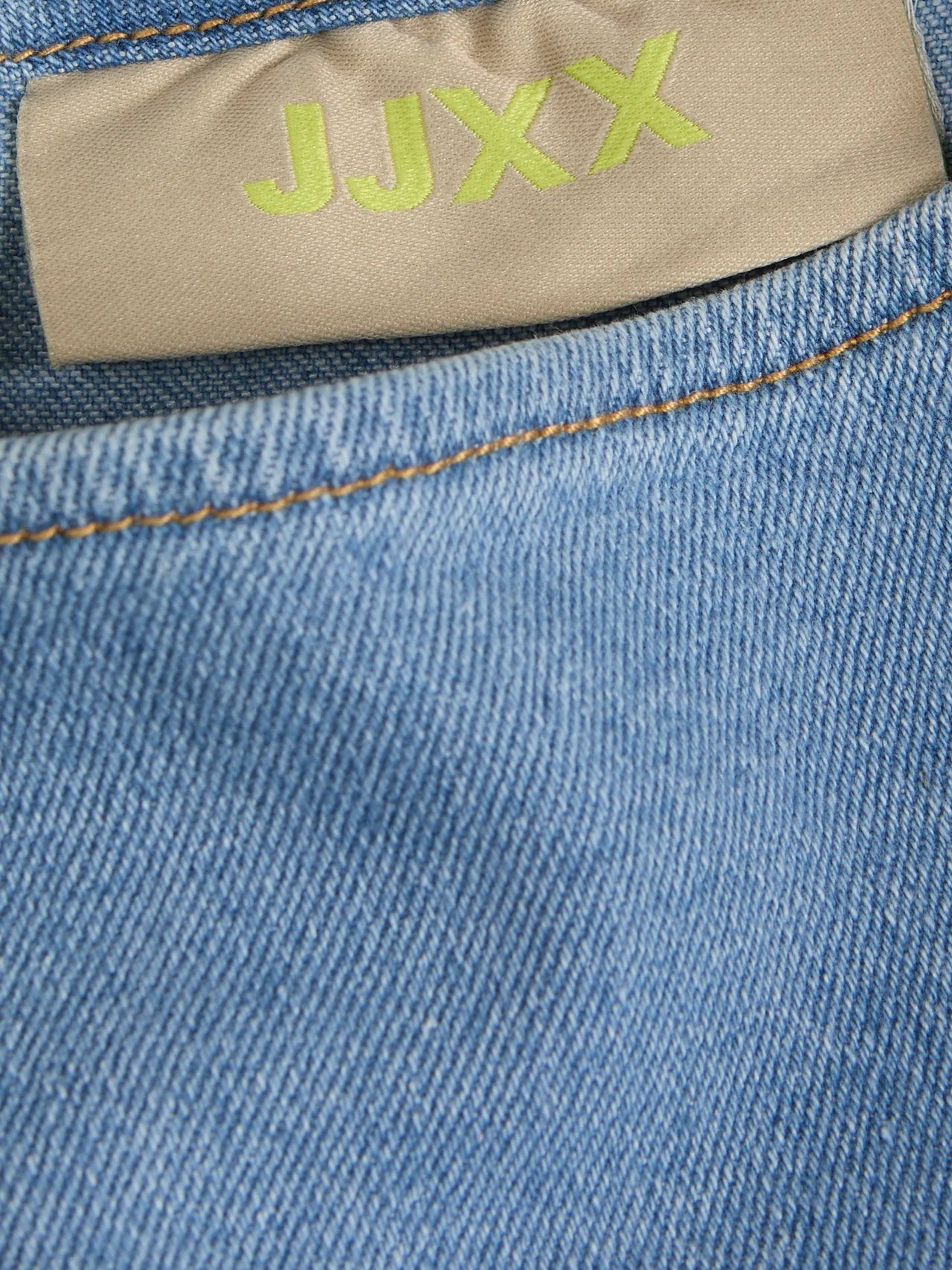 Stitching detail of this elevated casual denim dress with minimalist neckline and modern feminine silhouette.