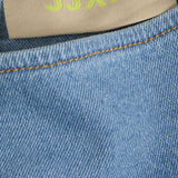 Stitching detail of this elevated casual denim dress with minimalist neckline and modern feminine silhouette.