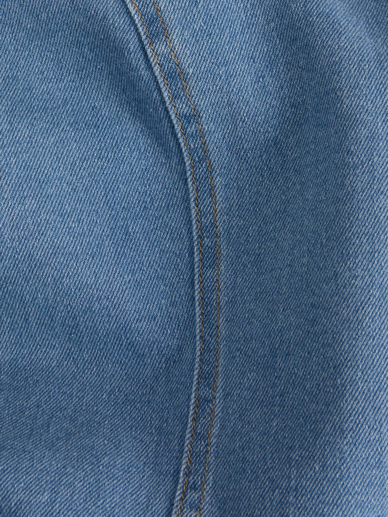 Material detail of modern denim sheath dress with minimalist design and elevated casual luxe appeal.