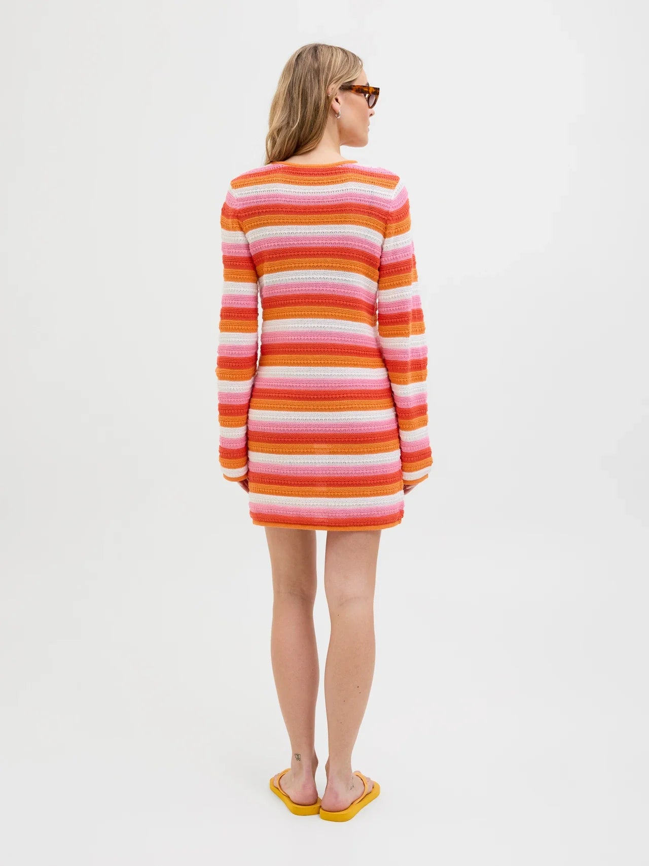 Fashion-forward striped crochet dress with 70s revival aesthetic and modern feminine silhouette